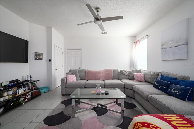 978 E 10th St, Apopka, FL 32703 - living area with light tile patterned flooring, ceiling fan, and a textured ceiling