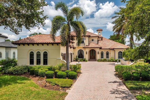 9253 Tibet Pointe Cir, Windermere, FL 34786 - mediterranean / spanish house featuring decorative driveway, stucco siding, and a tile roof