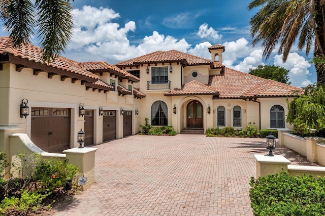 9253 Tibet Pointe Cir, Windermere, FL 34786 - mediterranean / spanish home with a balcony, decorative driveway, stucco siding, and a tiled roof