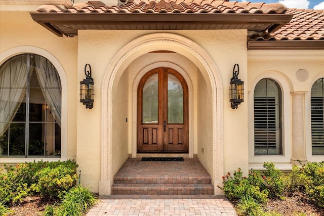 9253 Tibet Pointe Cir, Windermere, FL 34786 - view of exterior entry with a tiled roof and stucco siding