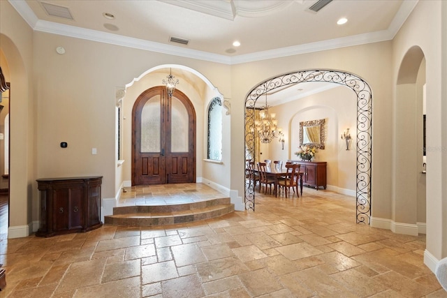 9253 Tibet Pointe Cir, Windermere, FL 34786 - foyer entrance featuring arched walkways, stone tile flooring, crown molding, a chandelier, and recessed lighting