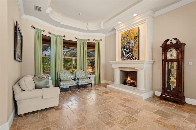 9253 Tibet Pointe Cir, Windermere, FL 34786 - sitting room with stone tile flooring, ornamental molding, a premium fireplace, baseboards, and a tray ceiling