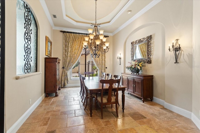 9253 Tibet Pointe Cir, Windermere, FL 34786 - dining area with stone tile floors, baseboards, a chandelier, a tray ceiling, and crown molding