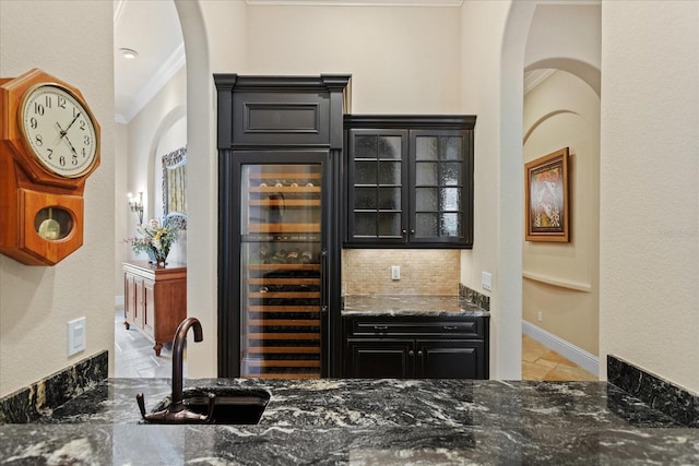 9253 Tibet Pointe Cir, Windermere, FL 34786 - indoor dry bar featuring beverage cooler, arched walkways, ornamental molding, backsplash, and baseboards