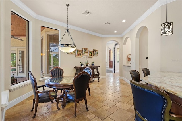 9253 Tibet Pointe Cir, Windermere, FL 34786 - dining room with arched walkways, stone tile flooring, ornamental molding, recessed lighting, and baseboards