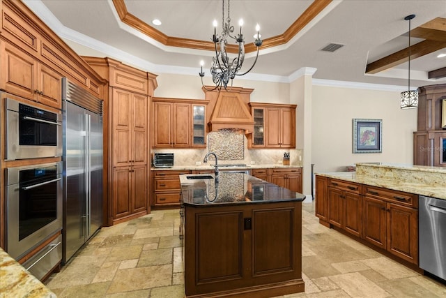 9253 Tibet Pointe Cir, Windermere, FL 34786 - kitchen featuring a chandelier, appliances with stainless steel finishes, stone tile floors, brown cabinets, and recessed lighting