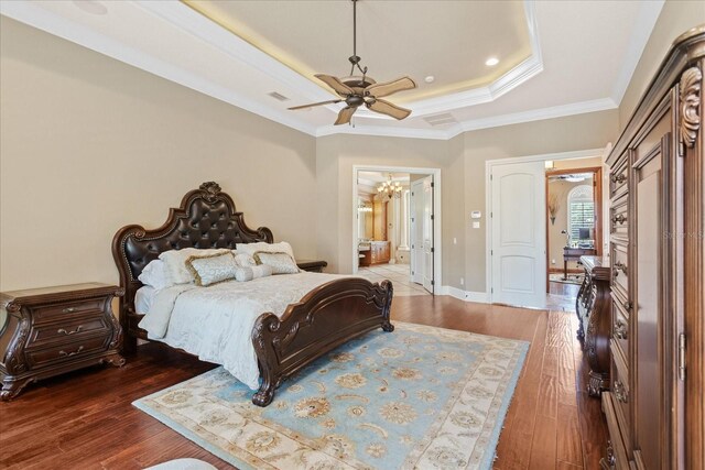 9253 Tibet Pointe Cir, Windermere, FL 34786 - bedroom featuring a raised ceiling, wood-type flooring, a chandelier, ornamental molding, and ensuite bath