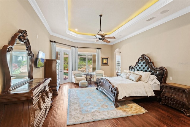9253 Tibet Pointe Cir, Windermere, FL 34786 - bedroom with access to exterior, dark wood finished floors, arched walkways, a tray ceiling, and ornamental molding