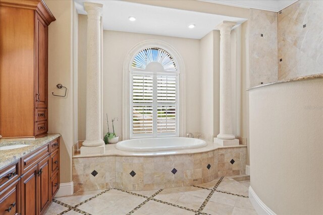 9253 Tibet Pointe Cir, Windermere, FL 34786 - bathroom with decorative columns, a bath, vanity, inlaid floor details, and tile patterned floors