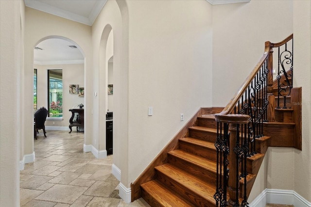 9253 Tibet Pointe Cir, Windermere, FL 34786 - stairway featuring ornamental molding, stone tile floors, baseboards, and arched walkways