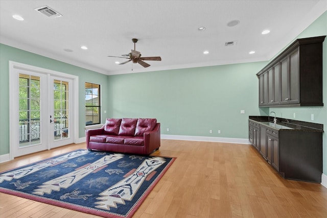 9253 Tibet Pointe Cir, Windermere, FL 34786 - living area featuring light wood finished floors, ceiling fan, baseboards, recessed lighting, and bar with sink