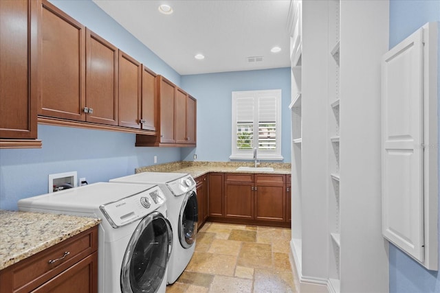 9253 Tibet Pointe Cir, Windermere, FL 34786 - laundry room featuring washer and dryer, cabinet space, stone tile floors, and recessed lighting