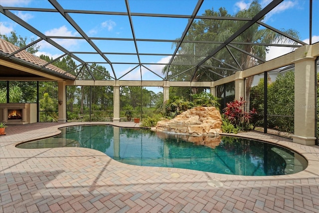 9253 Tibet Pointe Cir, Windermere, FL 34786 - swimming pool with a patio, a warm lit fireplace, and glass enclosure