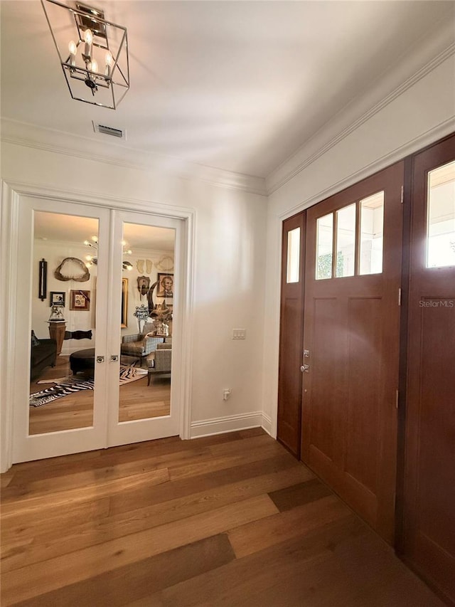 4309 W Beachway Dr, Tampa, FL 33609 - foyer with french doors, wood finished floors, crown molding, and baseboards