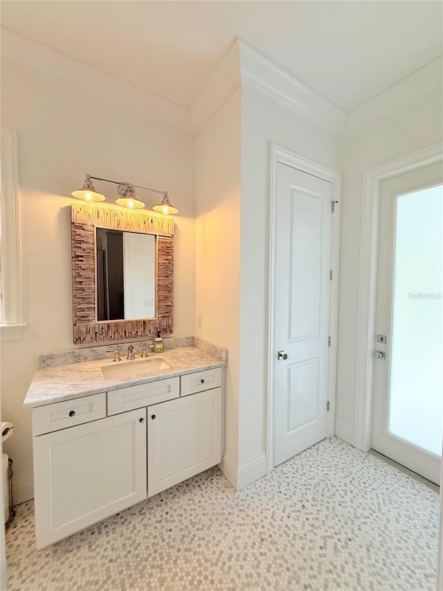 4309 W Beachway Dr, Tampa, FL 33609 - bathroom with vanity, tile patterned floors, baseboards, and crown molding
