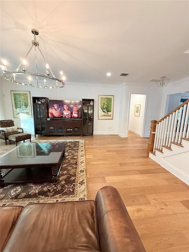 4309 W Beachway Dr, Tampa, FL 33609 - living room featuring a chandelier, light wood-type flooring, stairs, baseboards, and ornamental molding