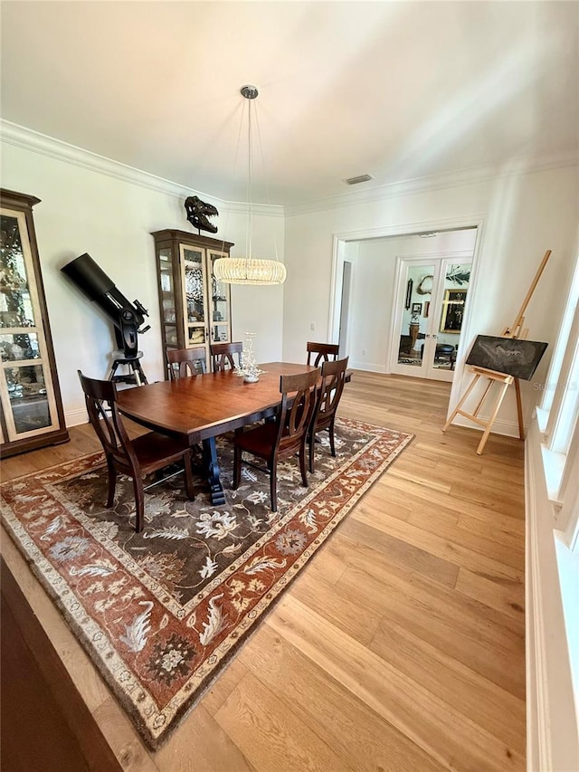 4309 W Beachway Dr, Tampa, FL 33609 - dining space featuring ornamental molding, light wood-style flooring, and french doors
