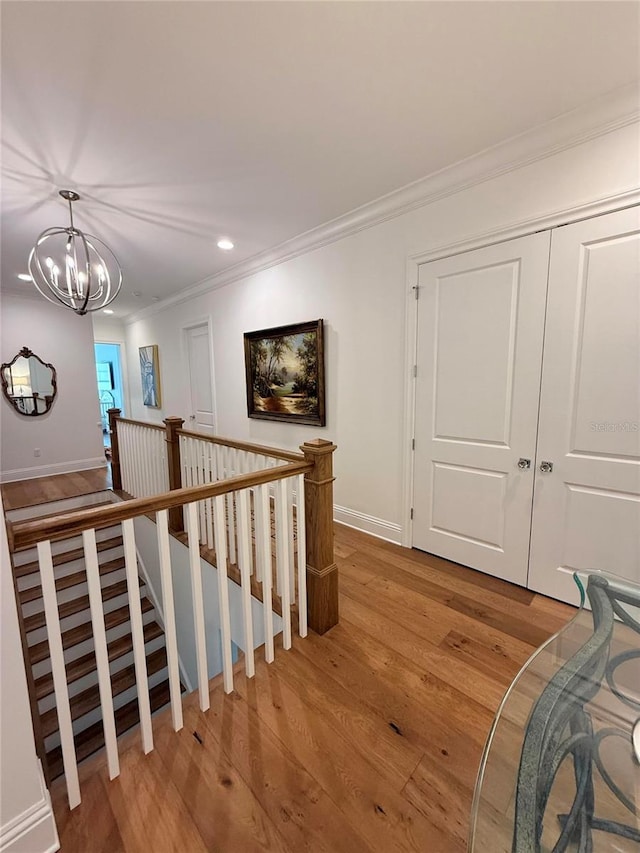 4309 W Beachway Dr, Tampa, FL 33609 - stairway featuring crown molding, wood finished floors, baseboards, a chandelier, and recessed lighting