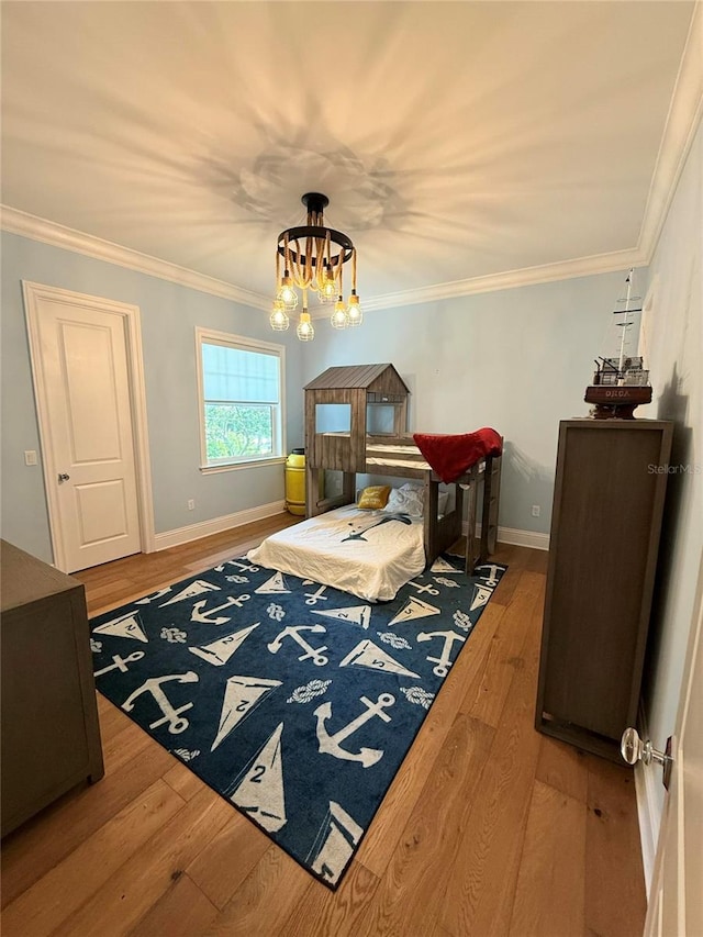 4309 W Beachway Dr, Tampa, FL 33609 - bedroom featuring wood finished floors, baseboards, ornamental molding, and a chandelier