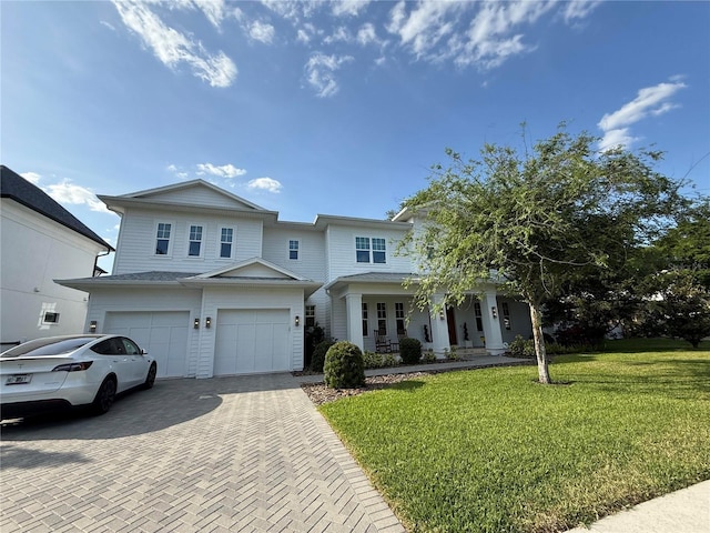 4309 W Beachway Dr, Tampa, FL 33609 - view of front facade with a garage, decorative driveway, a front yard, and a porch