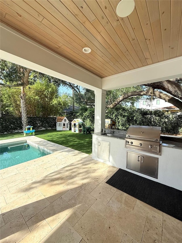 4309 W Beachway Dr, Tampa, FL 33609 - view of patio / terrace featuring a sink, an outdoor structure, and an outdoor pool