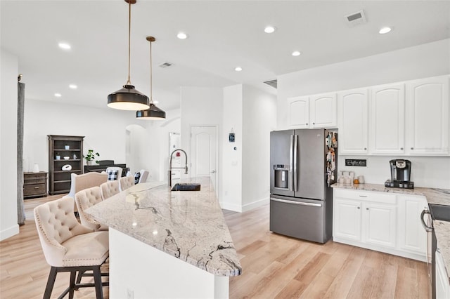 1932 Reed Hill Dr, Windermere, FL 34786 - kitchen with stainless steel fridge, a sink, arched walkways, light wood-type flooring, and recessed lighting