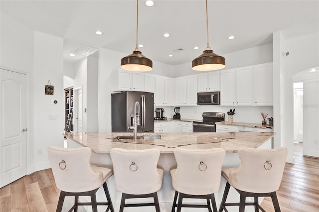 1932 Reed Hill Dr, Windermere, FL 34786 - kitchen featuring appliances with stainless steel finishes, a sink, recessed lighting, light wood-style floors, and white cabinetry
