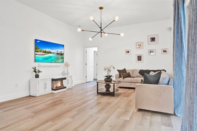 1932 Reed Hill Dr, Windermere, FL 34786 - living room featuring a chandelier, light wood-style flooring, baseboards, and a glass covered fireplace