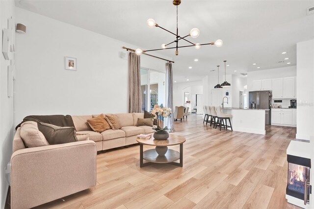 1932 Reed Hill Dr, Windermere, FL 34786 - living room featuring light wood-type flooring, a chandelier, and recessed lighting
