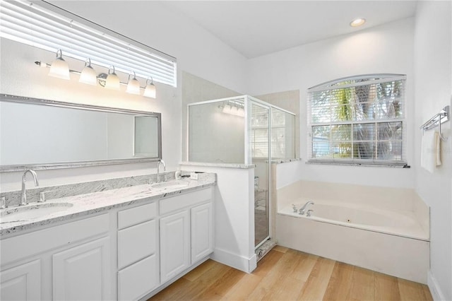 1932 Reed Hill Dr, Windermere, FL 34786 - full bathroom featuring a shower stall, a jetted tub, wood finished floors, double vanity, and recessed lighting