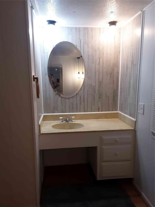 1525 Hilltop Rd, Casselberry, FL 32707 - bathroom featuring a textured ceiling, vanity, and wooden walls