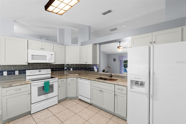 891 Licaria Dr, Ocoee, FL 34761 - kitchen featuring white appliances, tasteful backsplash, light tile patterned flooring, white cabinets, and a textured ceiling