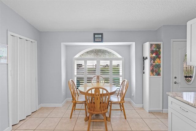 891 Licaria Dr, Ocoee, FL 34761 - dining space with light tile patterned floors and a textured ceiling
