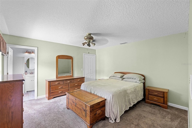 891 Licaria Dr, Ocoee, FL 34761 - carpeted bedroom with a textured ceiling, a ceiling fan, a closet, and ensuite bath