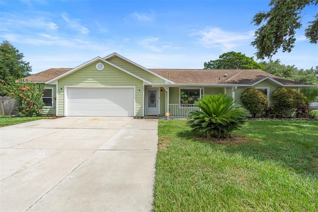 6906 Sawmill Blvd, Ocoee, FL 34761 - ranch-style home with a garage, a front lawn, driveway, and covered porch