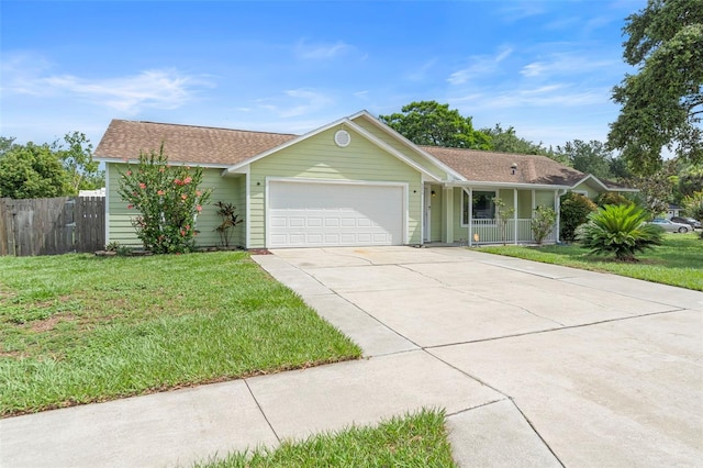 6906 Sawmill Blvd, Ocoee, FL 34761 - single story home featuring a garage, concrete driveway, covered porch, and a shingled roof