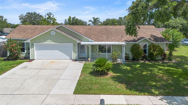 6906 Sawmill Blvd, Ocoee, FL 34761 - ranch-style home featuring covered porch, a garage, a front lawn, concrete driveway, and a shingled roof