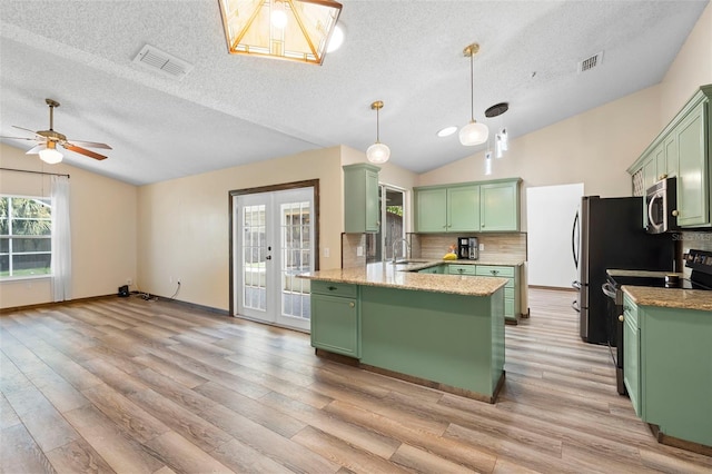 6906 Sawmill Blvd, Ocoee, FL 34761 - kitchen with green cabinets, black / electric stove, vaulted ceiling, stainless steel microwave, and a textured ceiling
