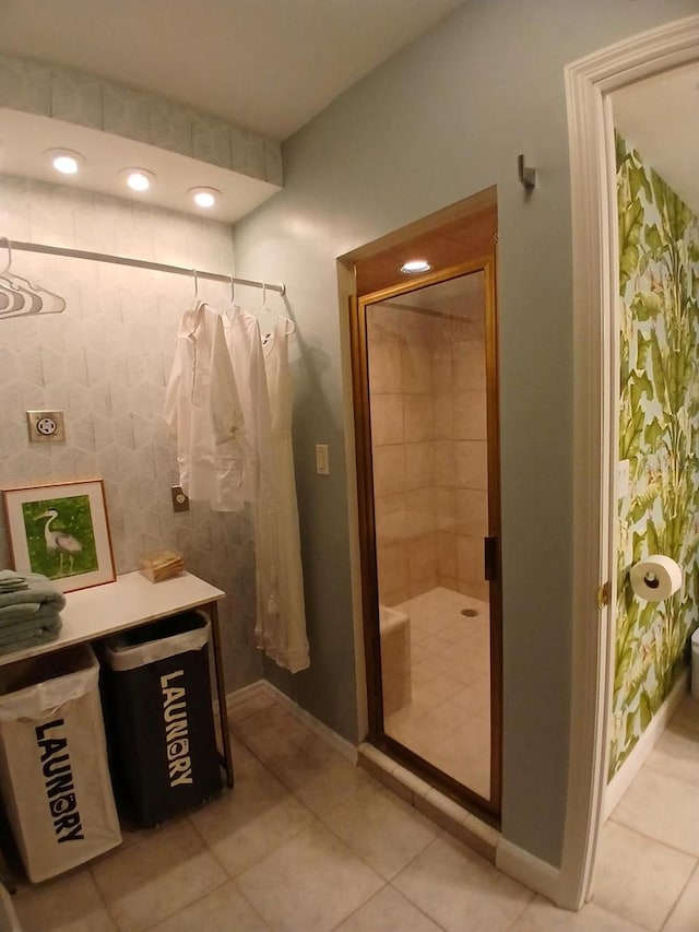 400 E Colonial Dr Unit 910, Orlando, FL 32803 - bathroom featuring a stall shower, baseboards, and tile patterned flooring