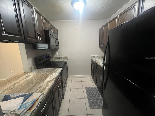 3270 S Semoran Blvd Unit 15, Orlando, FL 32822 - kitchen featuring black appliances, light tile patterned floors, a textured ceiling, baseboards, and light countertops