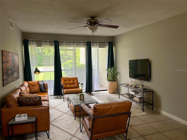 3270 S Semoran Blvd Unit 15, Orlando, FL 32822 - living area with plenty of natural light, a ceiling fan, light tile patterned floors, a textured ceiling, and baseboards