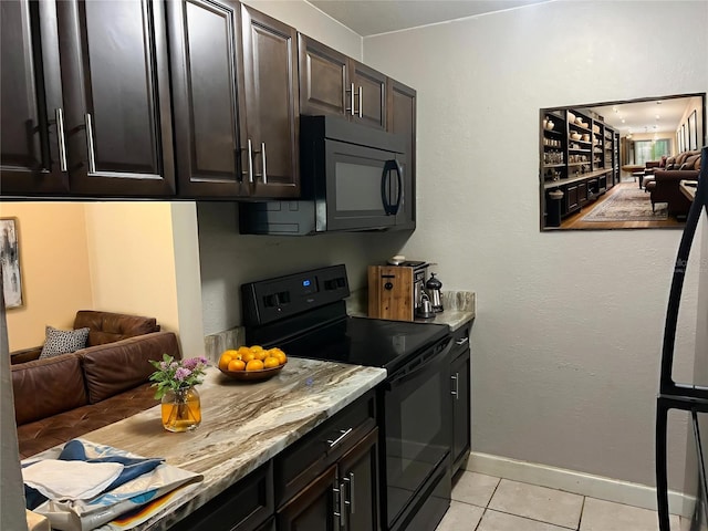 3270 S Semoran Blvd Unit 15, Orlando, FL 32822 - kitchen featuring black appliances, light tile patterned floors, open floor plan, and light stone countertops