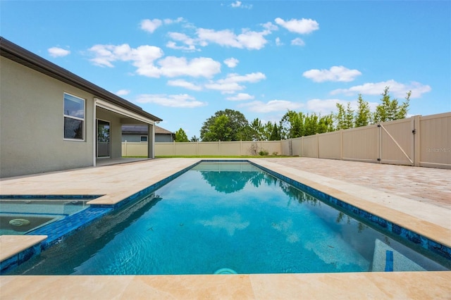 1740 Standing Rock Cir, Oakland, FL 34787 - view of swimming pool with a patio, a fenced backyard, a gate, and an in-ground hot tub