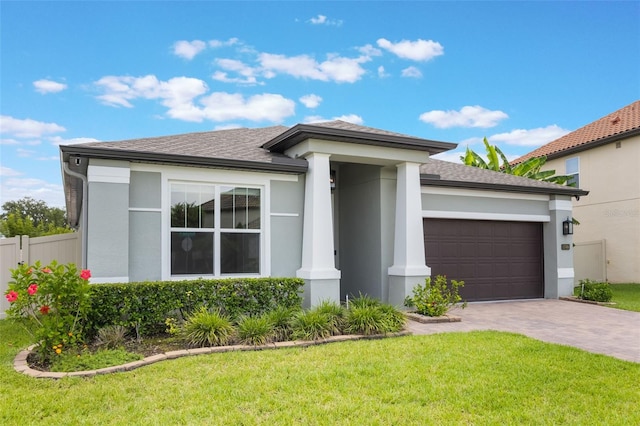1740 Standing Rock Cir, Oakland, FL 34787 - view of front of home with an attached garage, stucco siding, driveway, and a shingled roof