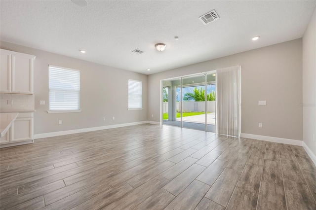 1740 Standing Rock Cir, Oakland, FL 34787 - empty room with light wood-style flooring, recessed lighting, and a textured ceiling
