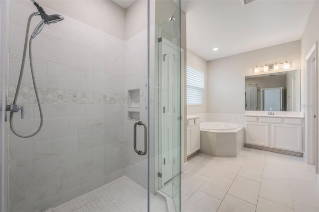 1740 Standing Rock Cir, Oakland, FL 34787 - bathroom with vanity, a shower stall, a garden tub, and tile patterned floors