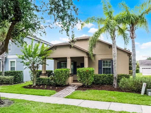 15647 Braintree Ln, Winter Garden, FL 34787 - view of front of house featuring stucco siding, a porch, and a front yard