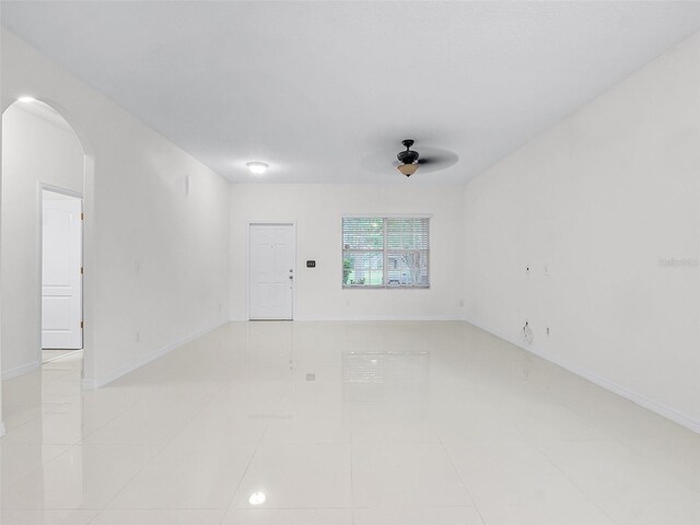 15647 Braintree Ln, Winter Garden, FL 34787 - unfurnished room featuring ceiling fan, arched walkways, and light tile patterned floors