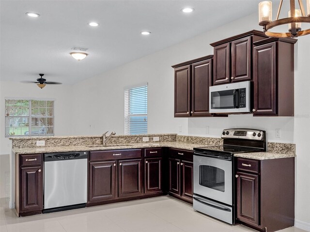 15647 Braintree Ln, Winter Garden, FL 34787 - kitchen featuring stainless steel appliances, a peninsula, healthy amount of natural light, a ceiling fan, and recessed lighting