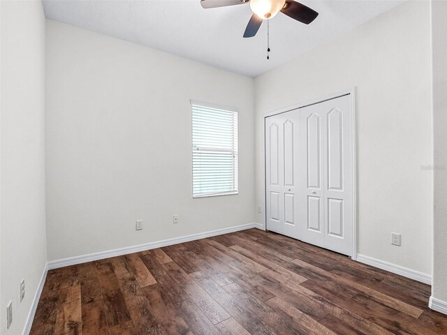 15647 Braintree Ln, Winter Garden, FL 34787 - unfurnished bedroom with dark wood-type flooring, a closet, and ceiling fan